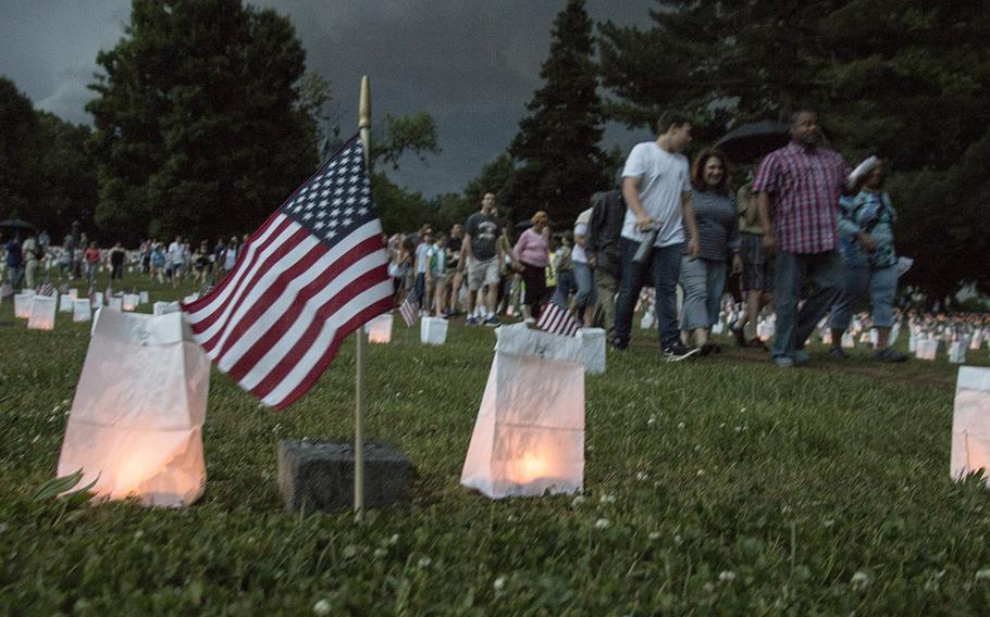 A thunderstorm chases visitors from the site during the 24th annual luminaria at Fredericksburg National Cemetery in Fredericksburg, Va., May 25, 2019.