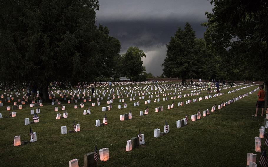 Storm clouds loom during the 24th annual luminaria at Fredericksburg National Cemetery in Fredericksburg, Va., May 25, 2019. Minutes later, the storm forced the evacuation of the cemetery.