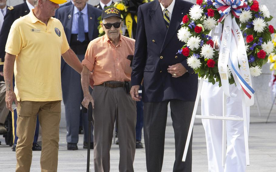 Army Air Force veteran Lou Perrone, who served as a ball turret gunner in a B-17 Flying Fortress during World War II, prepares to place a wreath at the National World War II Memorial in Washington on Memorial Day, May 27, 2019. With him is the chairman of the Friends of the National World War II Memorial, Josiah Bunting III.