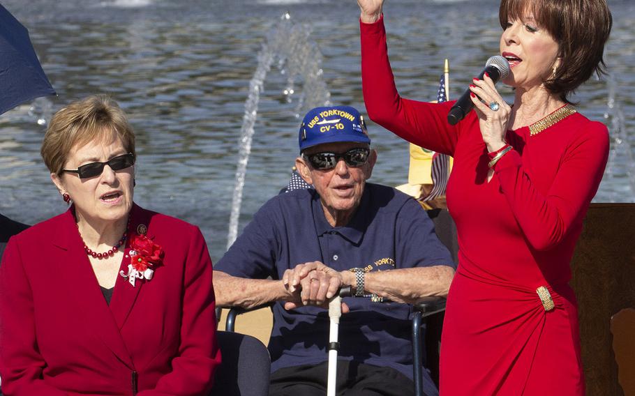 Rep. Marcy Kaptur, D-Ohio, and World War II veteran Andrew Abugelis listen as Dean Martin's daughter, Deana, sings on Memorial Day at the National World War II Memorial in Washington, D.C., May 27, 2019.