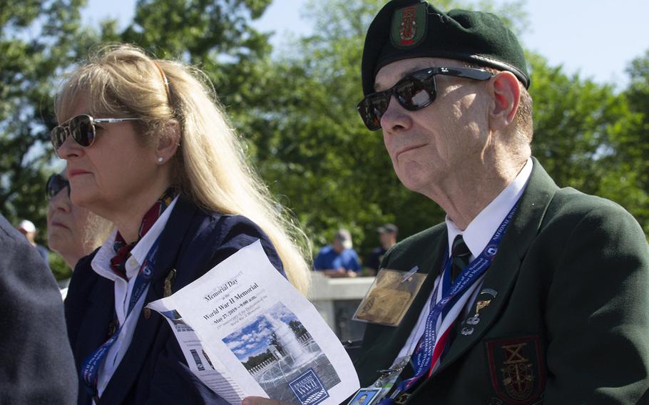 Visitors listen to a speaker on Memorial Day at the National World War II Memorial in Washington, D.C., May 27, 2019.