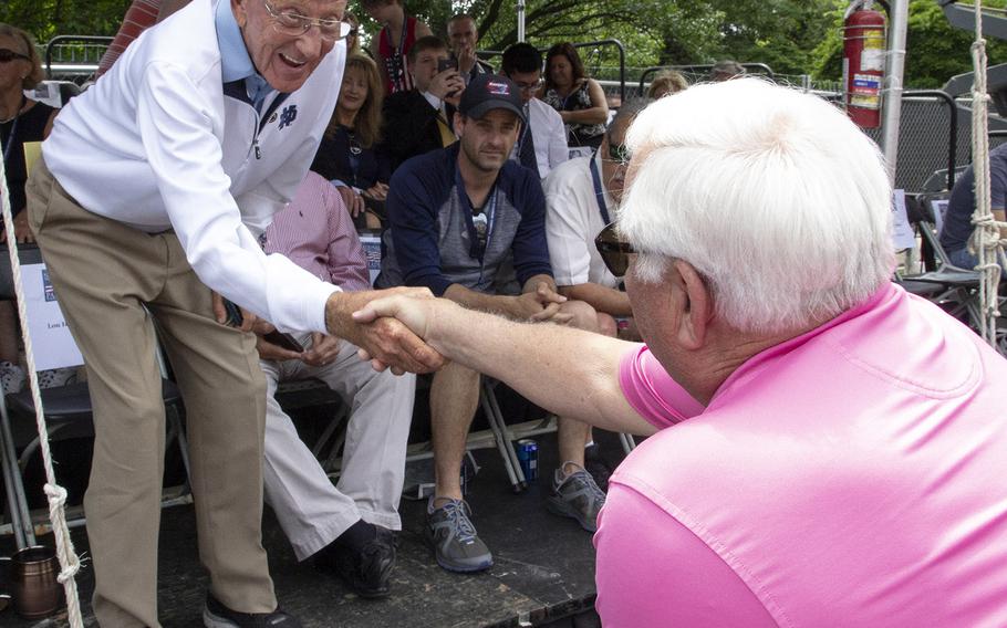 Football coaching legend Lou Holtz shakes hands with a military legend, Medal of Honor recipient Michael Thornton, before the National Memorial Day Parade in Washington, D.C., May 27, 2019.