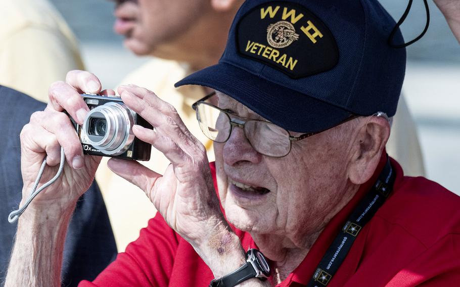 A veteran takes a photo during a ceremony marking the 75th anniversary of D-Day, June 6, 2019 at the National World War II Memorial in Washington, D.C.