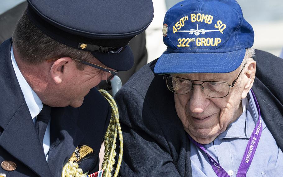 World War II veteran Dick Bailey, right, who flew three missions over Omaha Beach on D-Day, talks with Australian Wing Cmdr. Matt Stuckles during a ceremony marking the 75th anniversary of D-Day, June 6, 2019 at the National World War II Memorial in Washington, D.C.