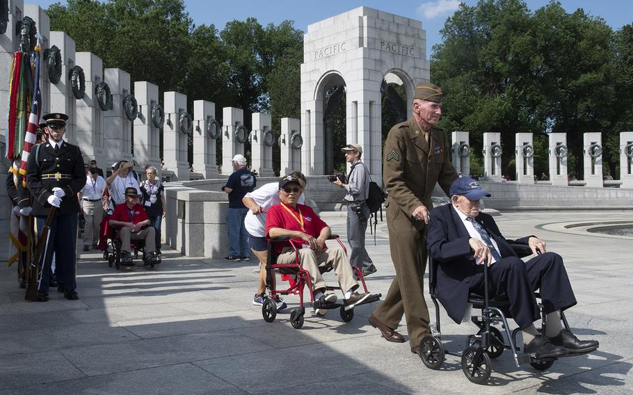 World War II veterans arrive at a ceremony marking the 75th anniversary of D-Day, June 6, 2019 at the National World War II Memorial in Washington, D.C.