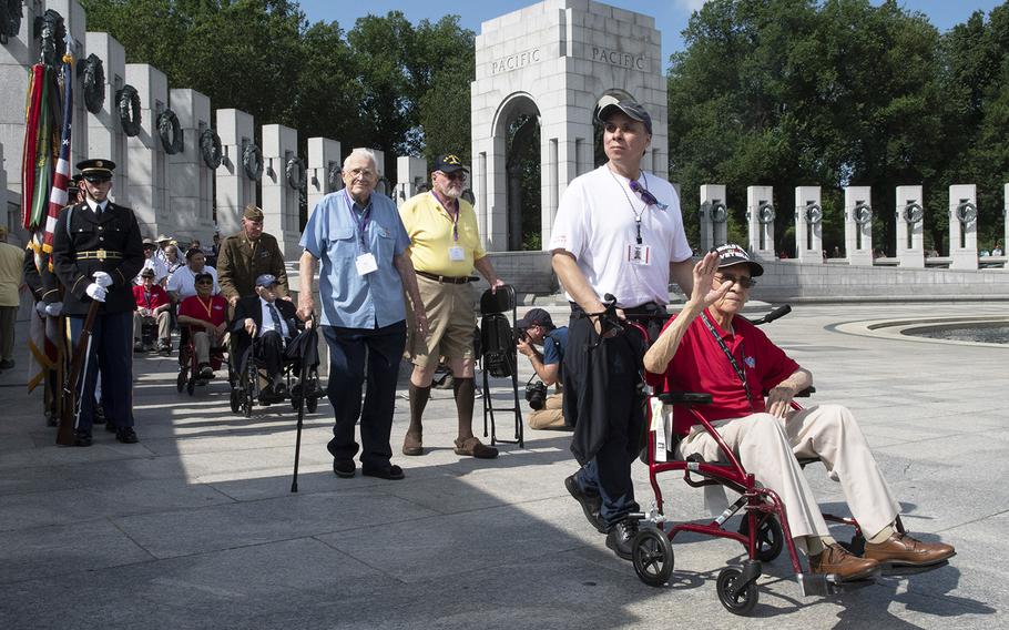 World War II veterans arrive at a ceremony marking the 75th anniversary of D-Day, June 6, 2019 at the National World War II Memorial in Washington, D.C.