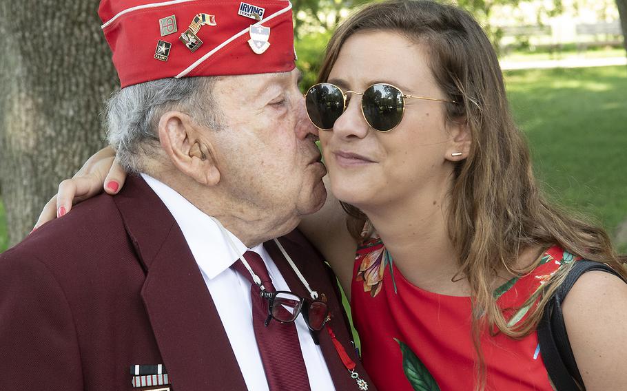 World War II veteran Robert Levine kisses his granddaughter, Sarah Powers, before a ceremony marking the 75th anniversary of D-Day, June 6, 2019 at the National World War II Memorial in Washington, D.C.