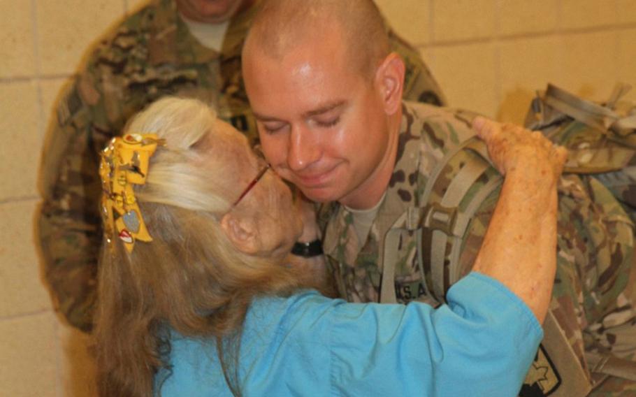 Capt. Edward Boncek receives a hug from Elizabeth Laird, affectionately known as "The Hug Lady," prior to boarding his flight to Afghanistan, July 11, 2013 at Fort Hood's Robert Gray Army Airfield. Soldiers asking the Defense Department and Fort Hood through a petition to rename in her honor the terminal at the airfield.
