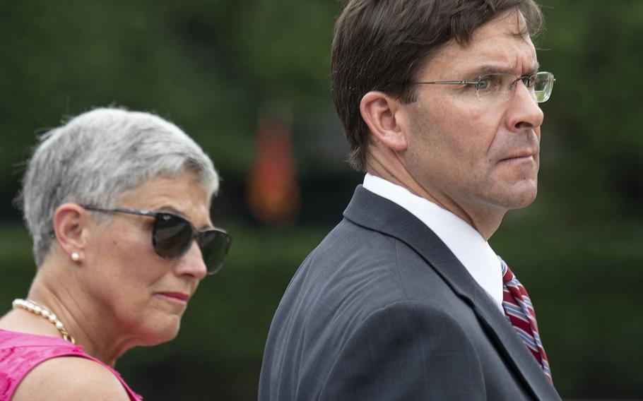 Acting Secretary of Defense Mark Esper, right, and D'Arcy Neller, the wife of retiring Marine Corps Commandant Gen. Robert Neller, left, watch the passage of command ceremony at the Marine Barracks Washington, D.C., July 11, 2019.