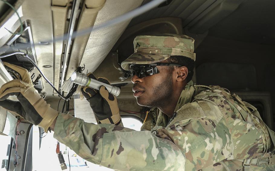 In a July 11, 2018 photo, Pvt. DeVante Williams, 1st Battalion, 124th Cavalry Regiment, searches through the cab of an 18-wheeler at the Texas-Mexico border's Eagle Pass point of entry as Texas guardsmen, part of Operation Guardian Support, assist Customs and Border Patrol agents.