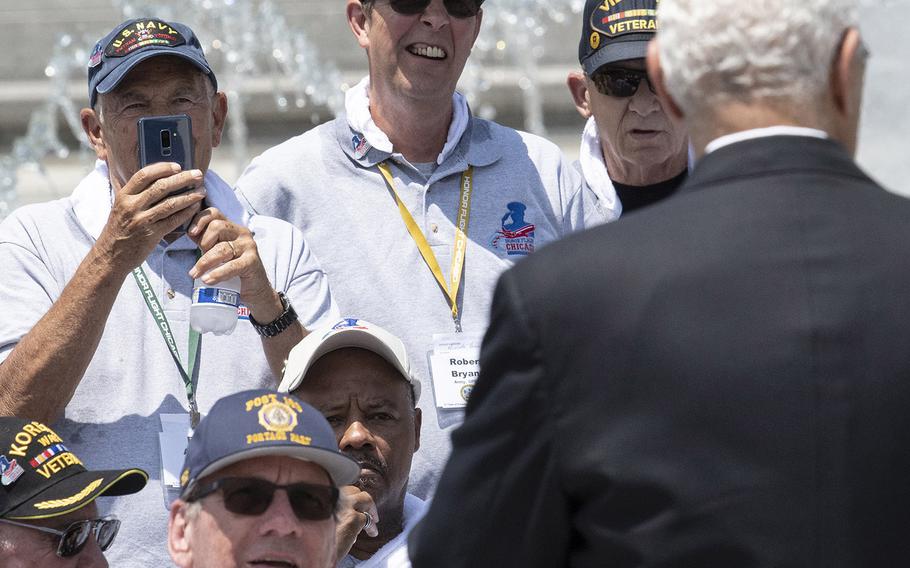 Visiting veterans listen to and take photos of former Secretary of State Colin Powell who spoke to the Honor Flight Chicago group at the National World War II Memorial in Washington, D.C. on Wednesday, July 10, 2019. 
