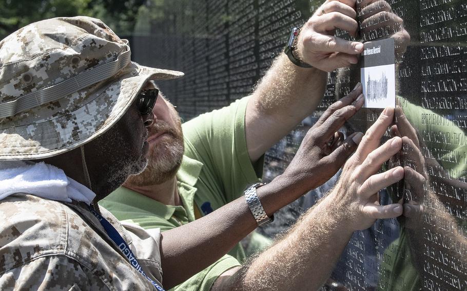 Vietnam veteran James Blue makes a rubbing of a name with the help of his Honor Flight Chicago guardian at the Vietnam Veterans Memorial in Washington, D.C. on Wednesday, July 10, 2019.