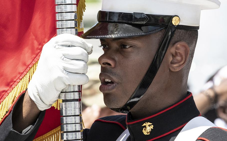 A member of the U.S. Marine Corps presents the Marine colors during a ceremony to honor visiting vets at the National World War II Memorial in Washington, D.C. on Wednesday, July 10, 2019.
