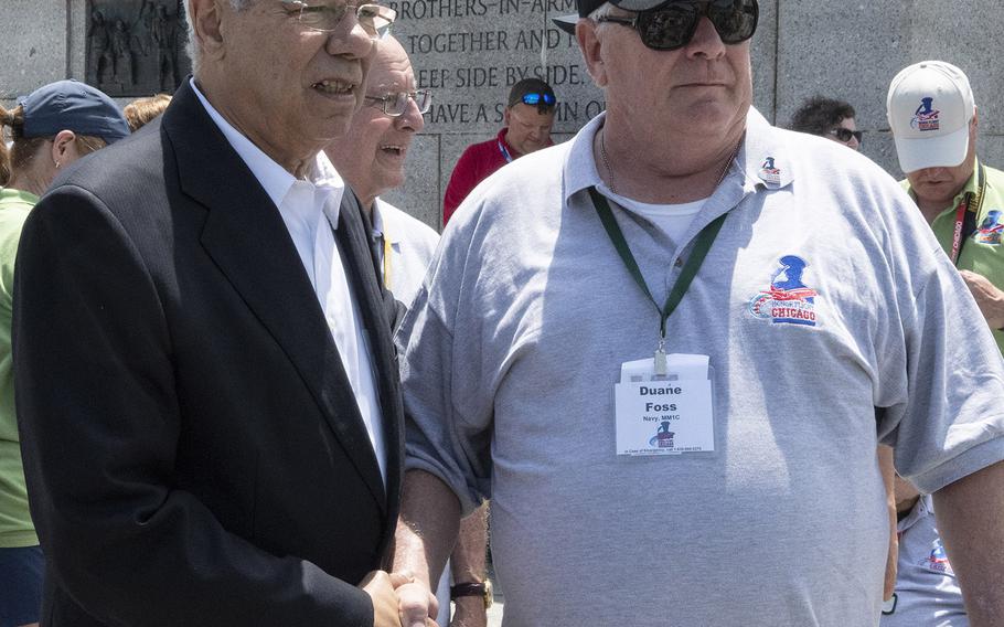 Former Secretary of State Colin Powell shakes hands with Duane Foss, right, a Navy veteran, at the National World War II Memorial in Washington, D.C. on Wednesday, July 10, 2019. Foss travelled to D.C. as part of Honor Flight Chicago's 92nd flight.
