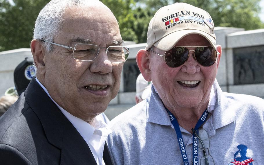 Former Secretary of State Colin Powell poses for a photo with a Korean War veteran at the National World War II Memorial in Washington, D.C. on Wednesday, July 10, 2019.