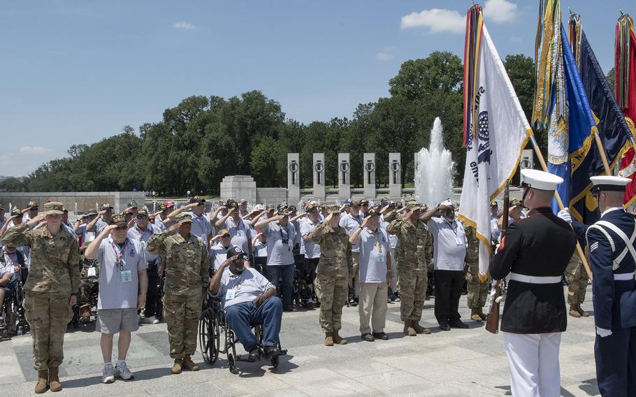 Veterans salute at the National World War II Memorial in Washington, D.C. during a ceremony honoring their visit on Wednesday, July 10, 2019.
