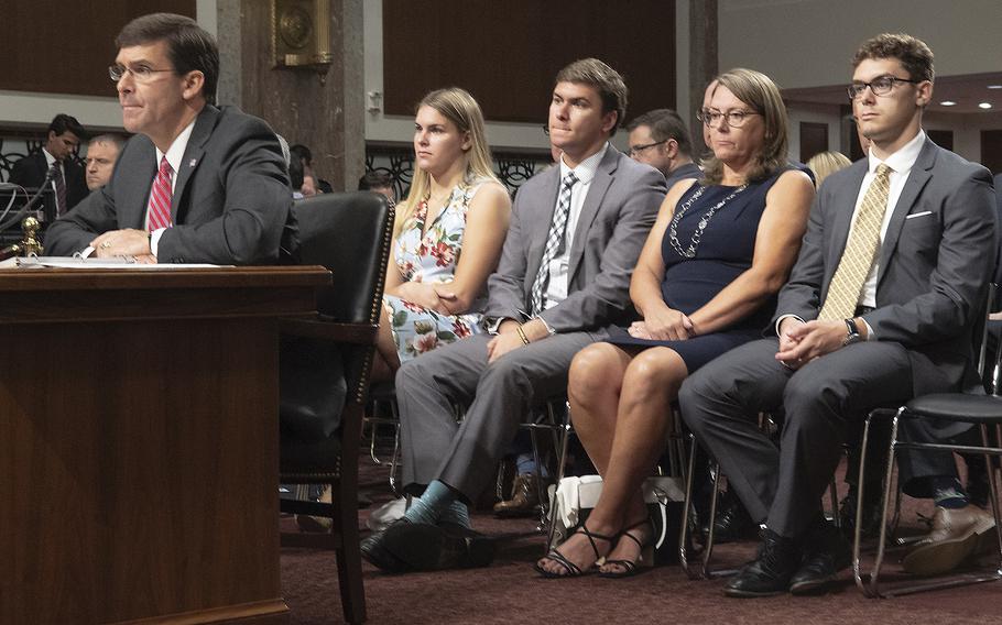 Secretary of the Army Mark Esper listens during a Senate Armed Services Committee hearing on his nomination to serve as secretary of defense, July 16, 2019 on Capitol Hill. Behind him are, left to right, his daughter Kate, son Luke, wife Leah and son John.