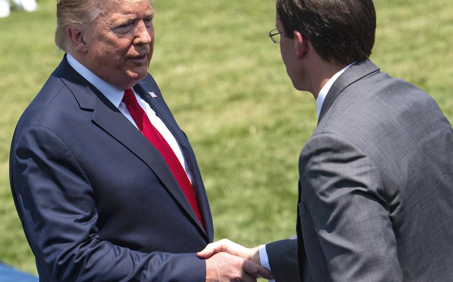 President Donald Trump shake Defense Secretary Mark Esper's hand on Thursday during a ceremony in honor of Esper being sworn in this week as Pentagon chief. 