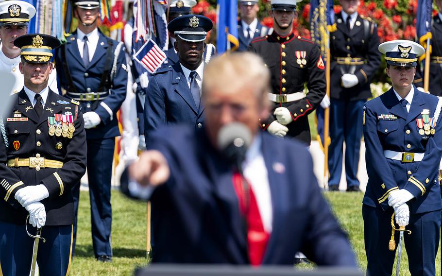 U.S. troops are pictured behing President Donald Trump outside the Pentagon on Thursday, July 25, 2019. The president was delivering remarks in honor of his new defense secretary, Mark Esper.