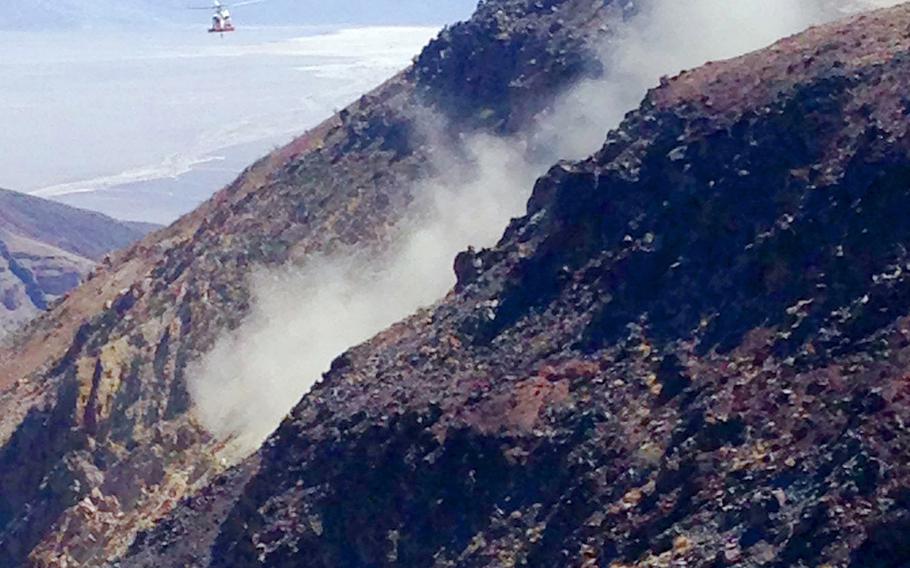 This photo provided by Panamint Springs Resort shows where a Navy fighter jet crashed Wednesday, July 31, 2019, in Death Valley National Park, injuring several people who were at a scenic overlook where aviation enthusiasts routinely watch military pilots speeding low through a chasm dubbed Star Wars Canyon, officials said. The crash sent dark smoke billowing in the air, said Aaron Cassell, who was working at his family's Panamint Springs Resort about 10 miles (16 kilometers) away. 