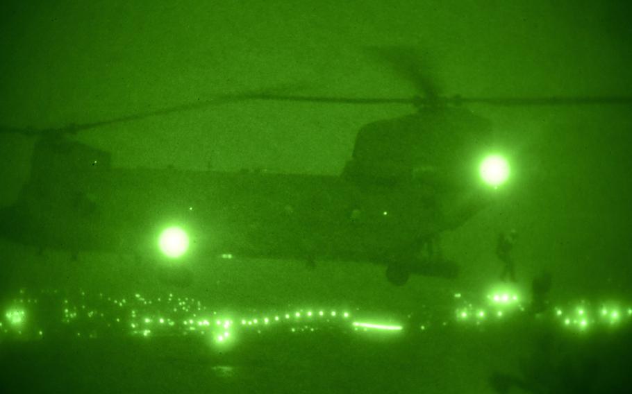 U.S. servicemembers assigned to Naval Special Warfare Command conduct helocasting operations from a CH-47 Chinook helicopter assigned to the 25th Combat Aviation Brigade at Pearl Harbor, Hawaii, July 25, 2019.