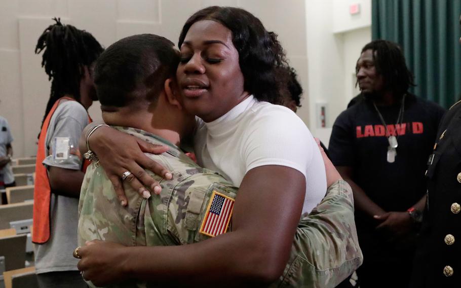 Myeshia Johnson, the widow of Sgt. LaDavid Johnson, right, hugs a member of the military after a ceremony awarding the Silver Star Medal to LaDavid Johnson, Friday, Aug. 16, 2019, in Miami Gardens, Fla. Johnson was killed in action during operations in Niger in 2017. 