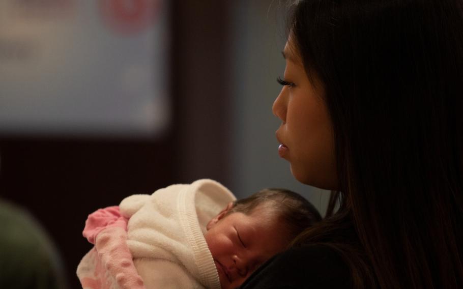 A recent mother comforts her newborn baby at an event at the Tower View Conference Center, Grafenwoehr Training Area, Germany, March 13, 2019.