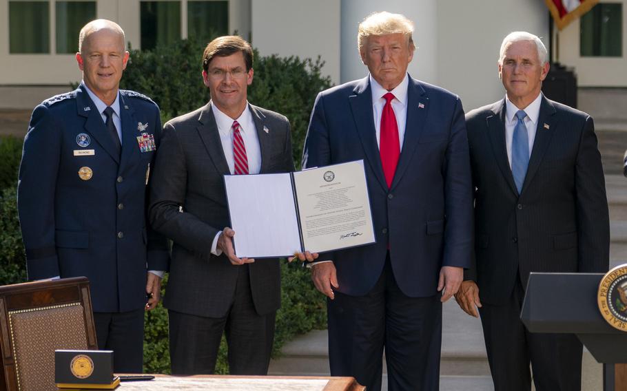 From left: Air Force Gen. Jay Raymond, Secretary of Defense Mark Esper, President Donald Trump and Vice President Mike Pence pose after a a White House ceremony establishing the new U.S. Space Command on Thursday, Aug. 30, 2019.