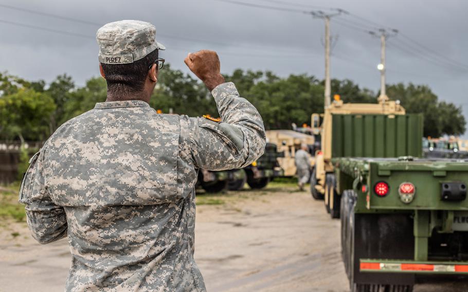Florida National Guardsman Sgt. Eliezer Perez, a truck driver from the 12-18th Transportation Company, West Palm Beach, Florida, ground-guides an A5 truck, Sept. 2, 2019. The 12-18th is preparing to distribute supplies in support of Hurricane Dorian.