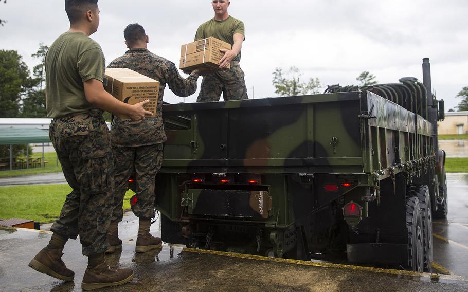 U.S. Marines with Marine Corps Air Station New River load Meals Ready to Eat onto a medium tactical vehicle replacement at station supply on MCAS New River, North Carolina, Sept. 5, 2019. Marines work to ensure all equipment and personnel are prepared for the upcoming heavy rains, strong winds, and flash flooding associated with Hurricane Dorian.