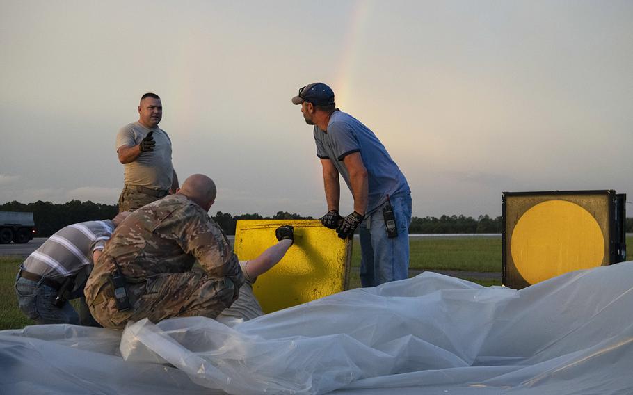 Members from the 4th Civil Engineer Squadron set up a generator for an aircraft arresting system ahead of Hurricane Dorian September 5, 2019, at Seymour Johnson Air Force Base, N.C. The AAS uses a special cable and belt system to stop jets if their brakes fail.