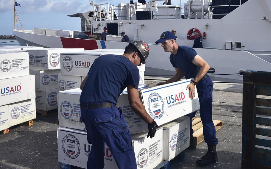 Members of the Coast Guard Cutter Raymond Evans (WPC-1110) offload boxes of supplies from the cutter Friday, Sept. 6, 2019 in Nassau, Bahamas, during Hurricane Dorian response efforts.