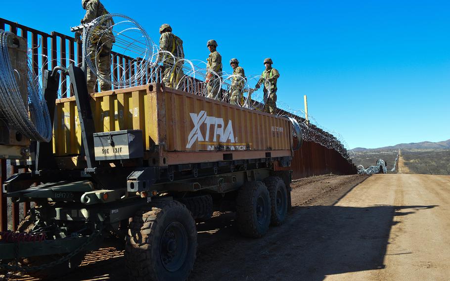 U.S. military personnel help fortify a border barrier in Sasabe, Arizona, on Feb. 7, 2019.