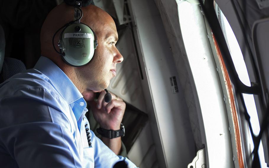 Rep. Brian Mast, R-Fla., looks out the window of a Coast Guard Air Station Miami HC-144 Ocean Sentry aircraft off the coast of Palm Beach, Fla., on Sept. 12, 2017. Mast flew with the Coast Guard for an overflight assessment of south Florida following Hurricane Irma.