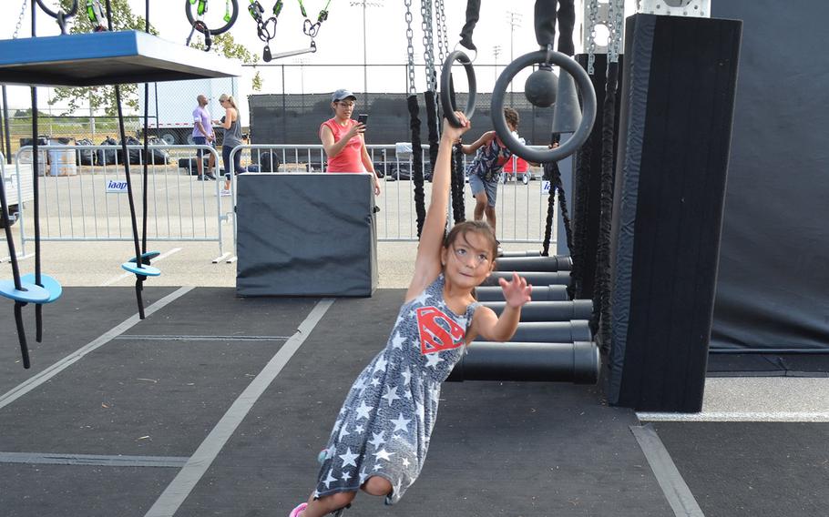 Kyndra Golloway, 8, plays on a children's version of an Alpha Warrior "battle rig" while waiting for her father, Air Force Staff Sgt. Seth Golloway of Hurlburt Field, Fla., to compete at the Alpha Warrior Proving Ground in San Antonio on Thursday.
