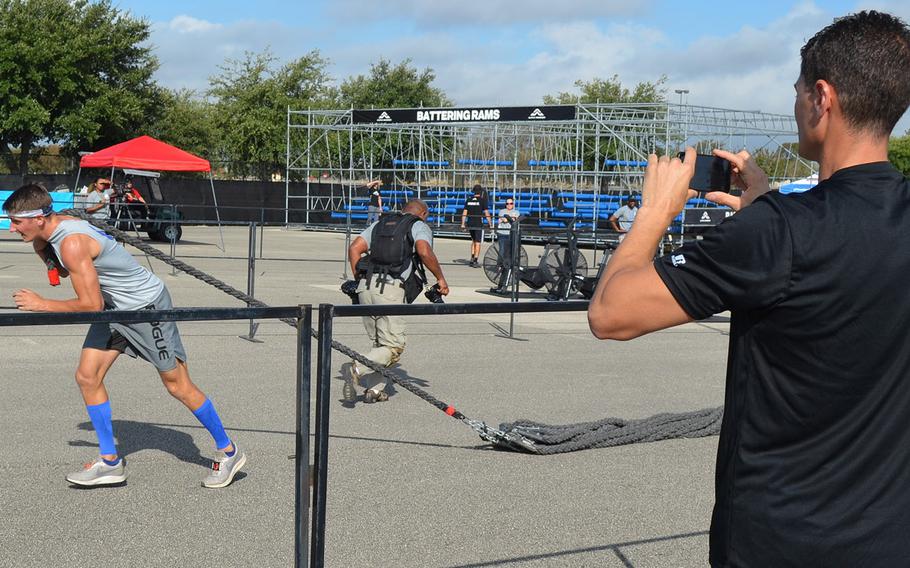 Army Lt. Col. Eric Palicia of U.S. Army Europe watches his younger brother, Air Force Capt. Noah Palicia of Yokota Air Base, Japan, compete at the Alpha Warrior Proving Ground in San Antonio on Thursday. Noah Palicia completed the course in 18 minutes, 39 seconds, the fastest run of the day.