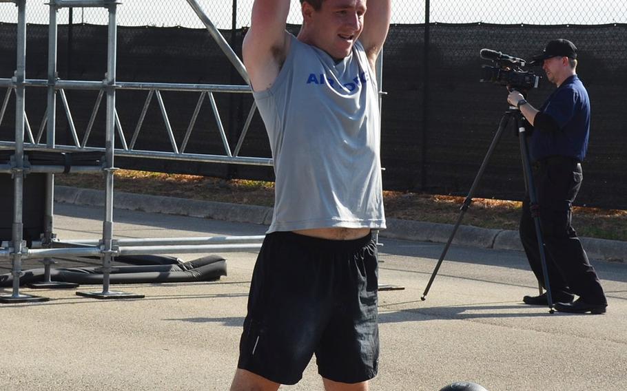 Air Force 2nd Lt. Jesse Montgomery of Robins Air Force Base, Ga., completes reps with a weighted ball before moving into the next obstacle at the Alpha Warrior Proving Ground in San Antonio on Thursday.