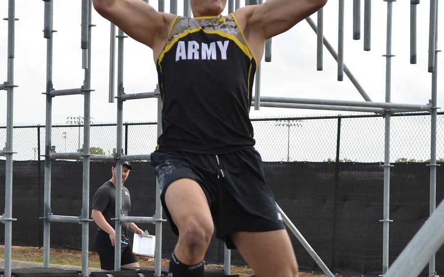 Army Lt. Col. Eric Palicia of U.S. Army Europe navigates an obstacle at the Alpha Warrior Proving Ground in San Antonio on Thursday. He was the top Army finisher with a time of 22 minutes, 54 seconds and earned a spot in the interservice battle Saturday, when he will compete against his brother, Air Force Capt. Noah Palicia.