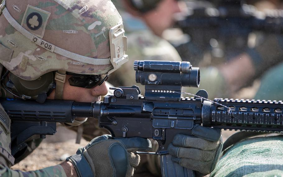 A soldier fires an M4 carbine, the military's version of Colt's AR-15, at a range on Qayyarah West Airfield, Iraq, June 4, 2019.