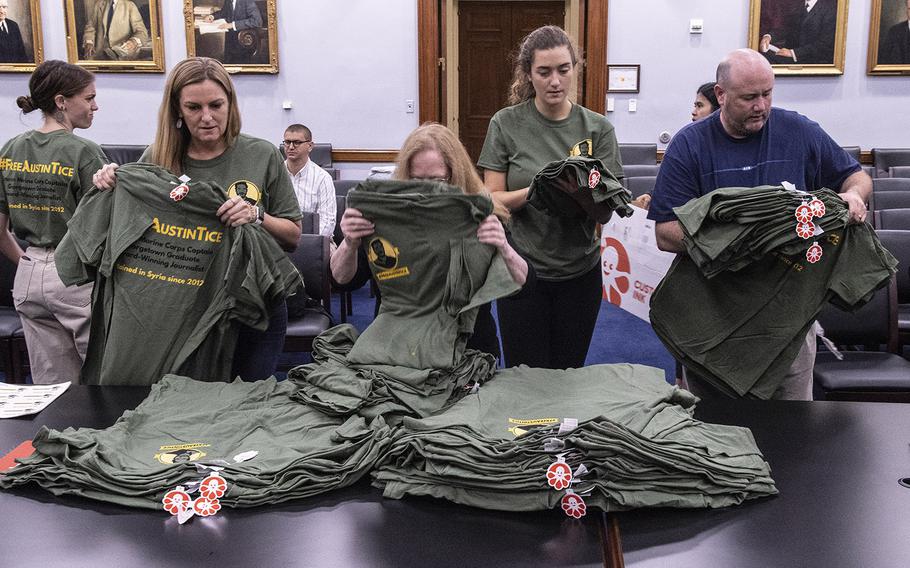 Volunteers sort t-shirts to be given to volunteers visiting Congressional offices to distribute information on missing journalist Austin Tice, Sept. 23, 2019 on Capitol Hill.