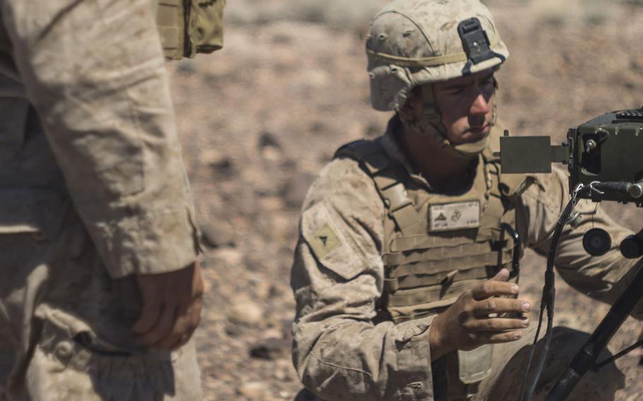 Then-Lance Cpl. Derek Diesel, prepares a portable laser designator to sight in on a target during an exercise on June 17, 2016.