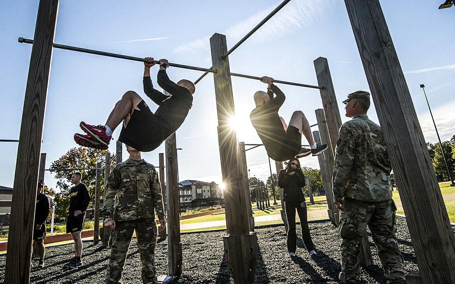 In a Oct. 23, 2018 file photo, soldiers assigned to the 128th Aviation Brigade at Fort Eustis, Va., attempt the leg tuck portion of the Army's new Army Combat Fitness Test.