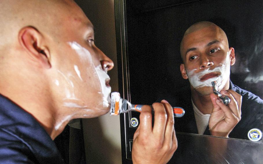 Lt. Gierag Andrews shaves in his stateroom before assuming the watch aboard the submarine USS Henry M. Jackson.