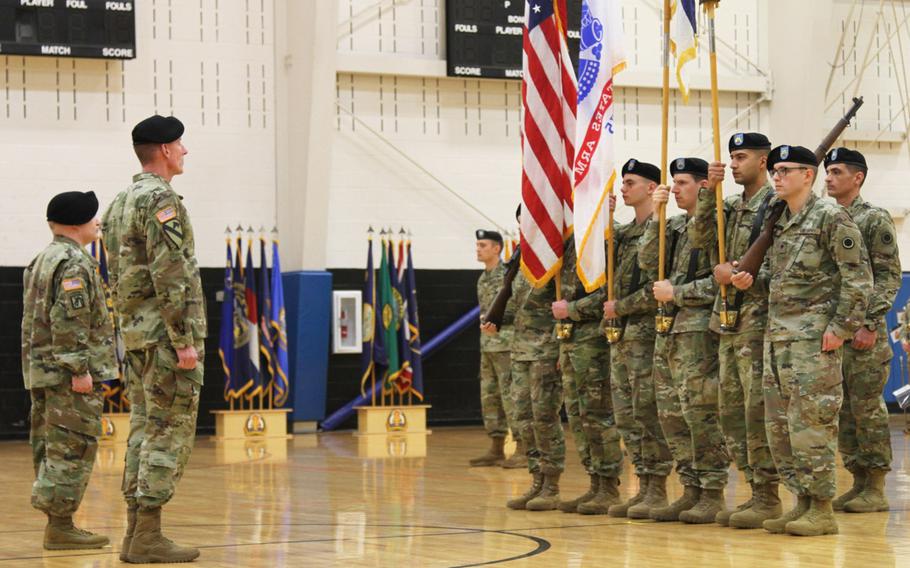 In a Jan. 11, 2019 photo, America's First Corps Commanding General Lt. Gen. Gary Volesky and Lt. Col. Derek Bothern, battalion commander of the newly activated Intelligence, Information, Cyber, Electronic Warfare and Space Detachment prepare to receive the unit flag for I2CEWS during a ceremony Jan. 11, 2019, at Joint Base Lewis McChord, Wash.