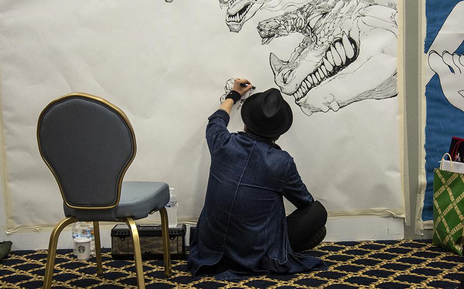 A Japanese artist works in the Yokota-Con artist alley at Yokota Air Base, Japan, Saturday, Oct. 19, 2019. 