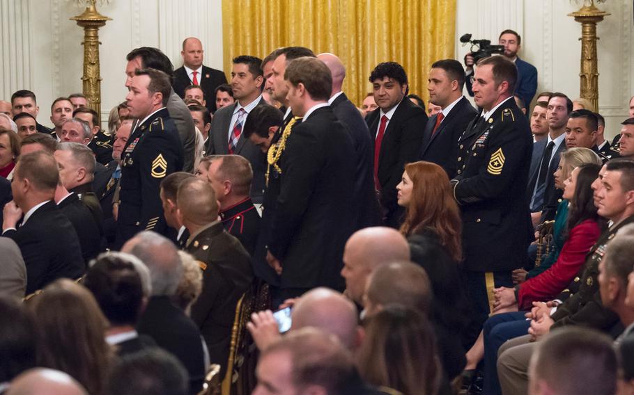 Members of an Army special forces team and two Afghan interpreters stand up as President Donald Trump recognizes them for their part in an April 2008 battle in Afghanistan, which resulted in their commrade, Master Sgt. Matthew Williams, receiving the Medal of Honor during a ceremony at the White House on Wednesday, Oct. 30, 2019.