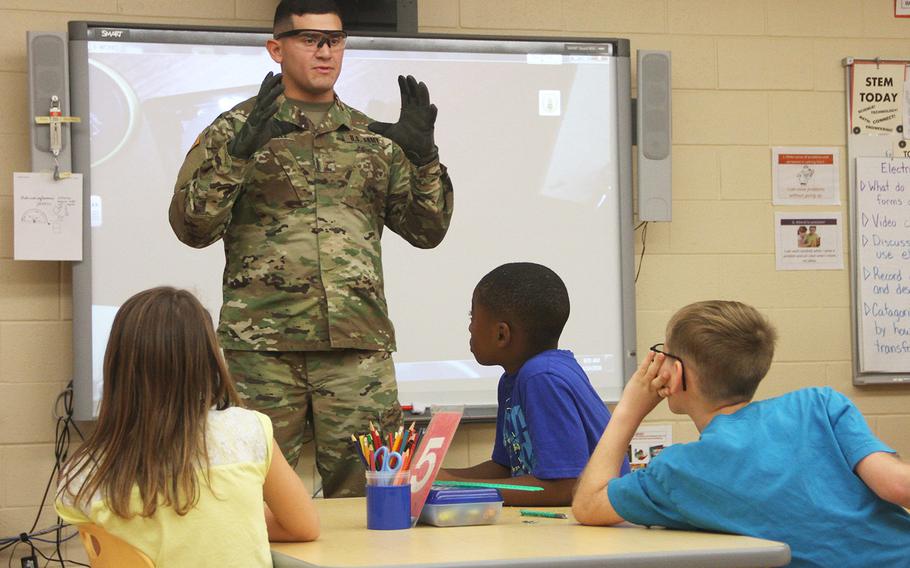 In a 2016 photo, 2nd Lt. Joshua Gonzalez of 9th Brigade Engineer Battalion, 2nd Infantry Brigade Combat Team, 3rd Infantry Division explains basic concepts of physics to Murray Elementary School fourth-grade students at Fort Stewart, Ga., during the school's second annual Science, Technology, Engineering and Mathematics Day.