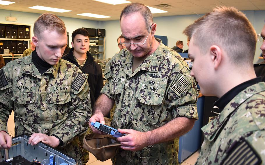In a Nov. 14, 2018 photo, Vice Adm. Charles A. Richard, commander of Naval Submarine Forces, examines computer parts with Naval Submarine School students during a tour of the SUBSCOL campus on Naval Submarine Base New London, Conn.