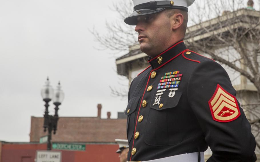 Staff Sgt. Joshua Stanton stands at ease while leading a formation of Marines with Special-Purpose Marine Air-Ground Task Force-Boston aboard the USS Arlington in the cold and rain of Boston’s Saint Patrick’s Day Parade March 15, 2015. The Marines marched to the stern commands shouted by the unit leader in disciplined, firm strides throughout the streets of South Boston. 