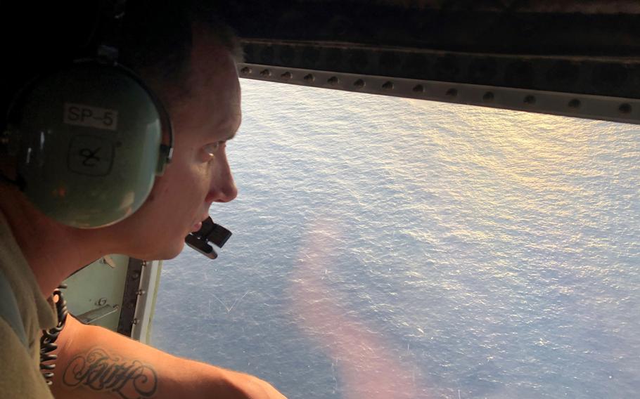 Tech. Sgt. Brett Corriveau, 39th Rescue Squadron loadmaster, scans the waters of the Gulf of Mexico from the inside of an HC-130P/N Combat King aircraft for any sign of the missing Airman from the 24th Special Operations Wing, Hurlburt Field, Florida on Nov. 6, 2019. Search and Rescue Airmen from the 920th RQW departed the base at approximately noon to join the search for the missing Special Tactics Airman. 